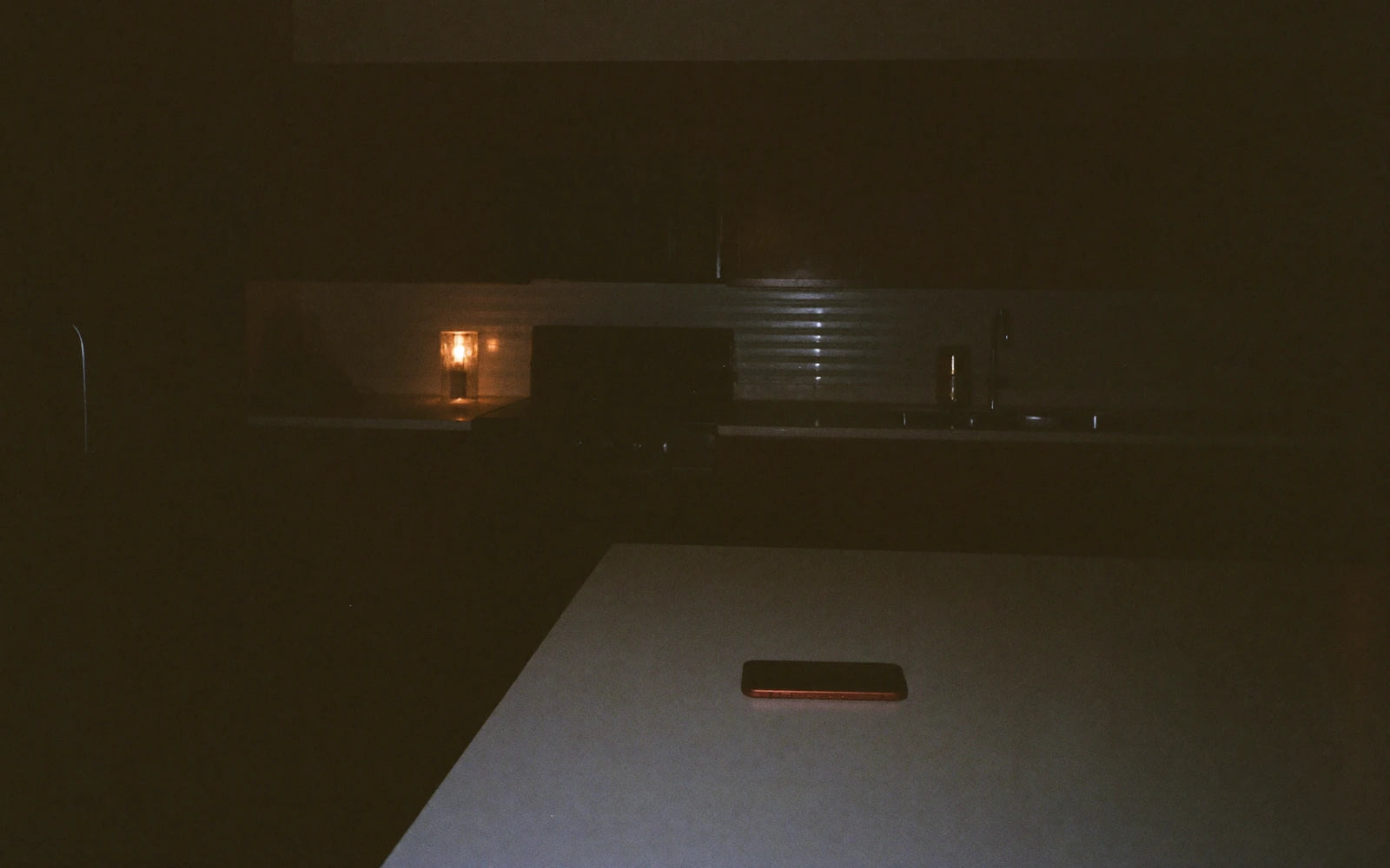 A kitchen late at night, nobody in it.