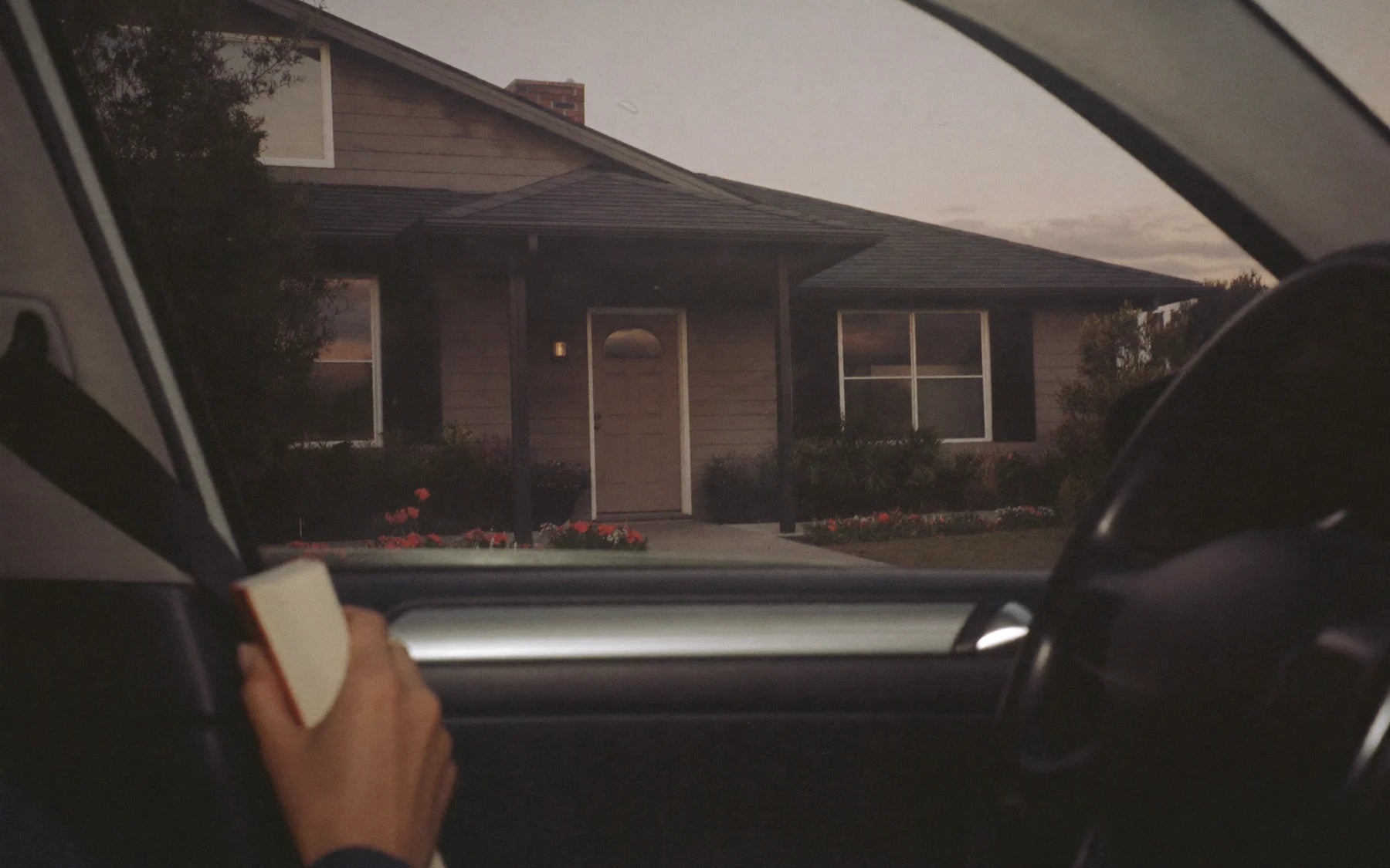 A house at night, seen from the driveway.