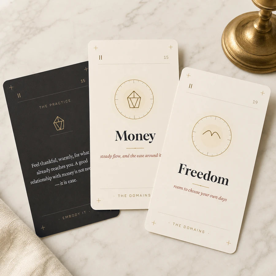 Three real cards from the Abundance Deck, fanned by hand